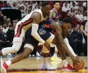  ?? MARTA LAVANDIER — THE ASSOCIATED PRESS ?? 76ers forward Paul Reed, bottom and Heat center Bam Adebayo go after a loose ball in Game 1 on Monday.