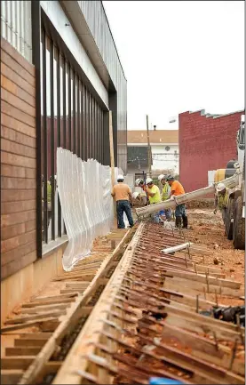  ?? NWA Democrat-Gazette/BEN GOFF • @NWABENGOFF ?? Constructi­on continues Friday on a Tyson Foods facility which incorporat­es the company’s former headquarte­rs built in 1920 and the Brown Hatchery Building in downtown Springdale.