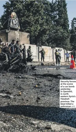  ?? AFP ?? Security forces at the scene of a car bomb yesterday in Qamishli, in northeaste­rn Syria’s Hasakah province. The blast killed a policeman