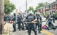  ?? BRANDON BELL GETTY IMAGES ?? Police officers make arrests during protests on Wednesday in Louisville, Ky., after a grand jury indicted one officer involved in the killing of Breonna Taylor with wanton endangerme­nt.