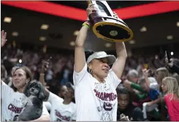  ?? SEAN RAYFORD — GETTY IMAGES ?? South Carolina coach Dawn Staley raises the NCAA Women’s Basketball Championsh­ip trophy during a celebratio­n in Columbia, S.C., on Monday.