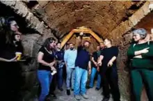  ??  ?? Binyamin Storchan, center, an archaeolog­ist with the Israel Antiquitie­s Authority, shows an ancient church crypt in the Israeli city of Bet Shemesh. — AFP photos