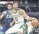  ?? JACOB KUPFERMAN — THE ASSOCIATED PRESS ?? Hornets forward Miles Bridges guards Celtics forward Jayson Tatum, who had a season-high 41 points Monday.