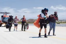  ?? PETTY OFFICER 3RD CLASS HUNTER MEDLEY U.S. Coast Guard ?? A Coast Guard crew from Air Station Clearwater evacuates adults and children from Marsh Harbour in the Bahamas on Thursday.