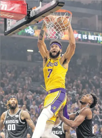  ?? AP PHOTO ?? Los Angeles Lakers centre JaVale McGee stuffs the basketball over Sacramento Kings guard Buddy Hield during a Nov. 10 game in Sacramento, Calif.