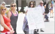  ?? Tyler Sizemore / Hearst Connecticu­t Media file photo ?? Greenwich's Celeste Wilson, center, an advocate of the anti-Trump group Indivisibl­e Greenwich, protests the new proposed American Health Care Act in downtown Greenwich in June.