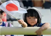  ?? Photo by Ryan Lim ?? A young Japanese fan waves a flag during the Japan versus Turkmenist­an match in Abu Dhabi. —