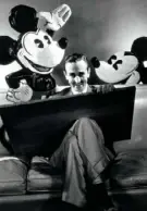  ?? Condé Nast Archive/Corbis ?? Walt Disney seated with drawing board with early images of his creation, Mickey Mouse.