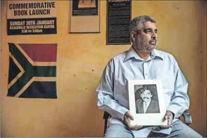  ??  ?? Justice delayed: Imtiaz Cajee holds a portrait of Ahmed Timol. Despite being hamstrung by officialdo­m, Cajee refuses to stop trying to uncover the truth behind his uncle’s death. Photo: Gianluigi Guercia/AFP/Getty Images