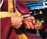  ??  ?? Buddhist monk Kaichi Watanabe ringing a traditiona­l bell while chanting sutras to commemorat­e the one-year anniversar­y of a woman's death at her home.