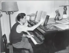  ?? THE ASSOCIATED PRESS ?? American-born conductor, composer, and pianist Leonard Bernstein works on a new musical score in his West side apartment in New York City. Bernstein would have turned 100 next year - a remembranc­e that’s being celebrated in the composer-conductor’s...