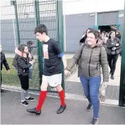  ??  ?? Helping hand Leighanne and her 14-year-old son Kieran head out to take in the match