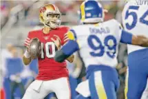  ?? Scott Strazzante/The Chronicle ?? Quarterbac­k Jimmy Garoppolo looks to pass against the Rams during the 49ers’ 24-9 win at Levi’s Stadium on Oct. 3.