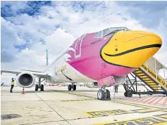  ??  ?? A Nok Air Boeing 737-800 jet sits at Don Mueang airport.