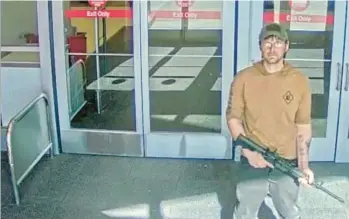  ?? OMAHA POLICE DEPARTMENT ?? In an image from security camera footage, a man identified as Joseph Jones and armed with an AR-15-style rifle stands Jan. 31 at a Target store in Omaha, Neb. Despite having schizophre­nia. Jones was able to buy guns legally.