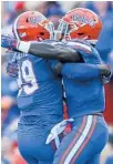  ?? BRONTE WITTPENN/TAMPA BAY TIMES ?? Florida’s Jachai Polite (99) and Vosean Joseph (11) celebrate after breaking up a play by the LSU offense Saturday at the Swamp.