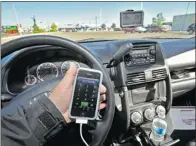  ?? LARRY WONG/ POSTMEDIA NEWS ?? While the presence of a passenger led to the poorest performanc­e, drivers felt remote exchanges were the most distractin­g.