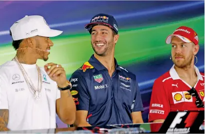  ?? Reuters ?? Formula One Mercedes driver Lewis Hamilton of Great Britain, Red Bull Racing driver Daniel Ricciardo of Australia and Ferrari driver Sebastian Vetterl of Germany at a Press conference in Melbourne on Thursday. —