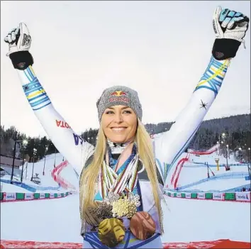  ?? Marco Trovati Associated Press ?? LINDSEY VONN, shown with medals she has won throughout her career, became the oldest woman to earn a medal at the world championsh­ips. The 34-year-old took the bronze in her final race Sunday.