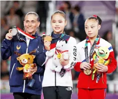  ??  ?? Gold medallist Yeo Seo-jeong of South Korea (centre) with silver medallist Oksana Chusovitin­a of Uzbekistan and bronze medallist Pyon Rye Yong of North Korea on the podium. — Reuters photo