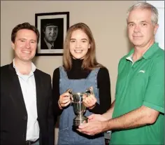  ??  ?? Aisling Gouldson (violin), winner of the Alan Cutts Cup for her rendition of Allegro form Concerto in A Minor by Vivaldi, is presented with her trophy by school principal David Creevy and school director Karl Richards.