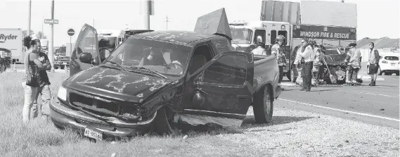  ?? NICK BRANCACCIO ?? Crews work the scene of a two-vehicle collision on E. C. Row at Banwell Road on Friday. The intersecti­on has been identified as one of the worst in the city for car crashes.