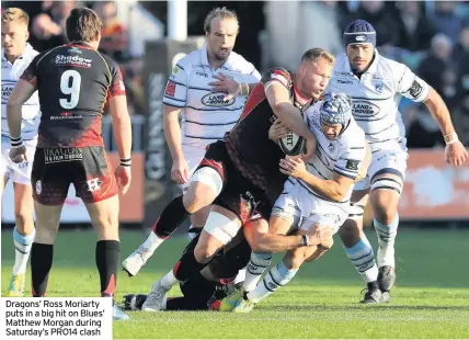  ??  ?? Dragons’ Ross Moriarty puts in a big hit on Blues’ Matthew Morgan during Saturday’s PRO14 clash