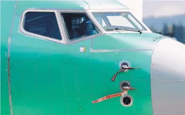  ?? TED S. WARREN/ASSOCIATED PRESS ?? Caution flags have been attached to flight sensors on a Boeing 737 MAX 8 airplane in April that was being built at Boeings assembly facility in Renton, Washington.