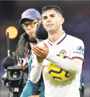  ?? Anthony Devlin / Associated Press ?? Chelsea’s Christian Pulisic salutes the fans after scoring a hat trick during his team’s match against Burnley on Saturday.