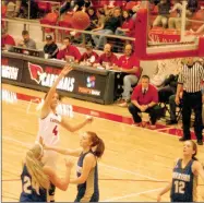  ?? MARK HUMPHREY ENTERPRISE-LEADER ?? Farmington sophomore Madisyn Pense takes a onehanded shot in the lane over two Harrison defenders. Pense scored 17 points, but the Lady Cardinals lost, 55-53, on a lastsecond shot at home Jan. 24.