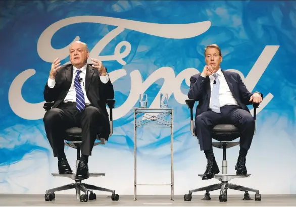 ?? PAUL SANCYA/THE ASSOCIATED PRESS ?? Jim Hackett, Ford Motor Co.’s newly named chief executive, left, speaks with Bill Ford Jr., executive chairman., in Dearborn, Mich., on Monday.