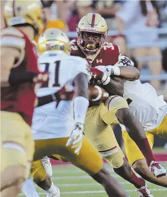  ?? STAFF PHOTOS BY JOHN WILCOX ?? OUT OF THEIR HANDS: Above, BC running back Jon Hilliman fumbles on a tackle by Notre Dame’s Julian Okwara yesterday at Alumni Stadium. A promising first half quickly came unraveled for coach Steve Addazio (below) and the Eagles, who lost 49-20 in their...