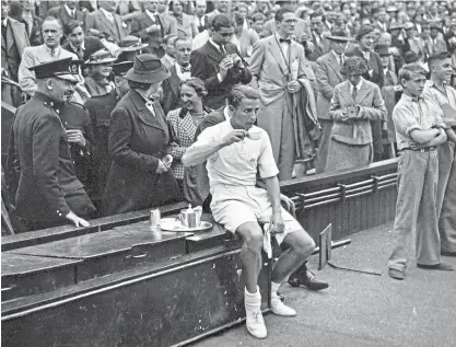  ?? ?? Sporting shorts: Tennis royalty Bunny Austin sips tea during a match at Wimbledon in 1937