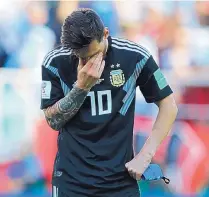  ?? RICARDO MAZALAN/ASSOCIATED PRESS ?? Argentina’s Lionel Messi, whose penalty kick was stopped, covers his face during his team’s 1-1 draw with Iceland during a World Cup opener in Moscow.