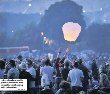  ?? Ben Birchall ?? Revellers light and let go of sky lanterns. Now councillor­s are backing calls to ban them