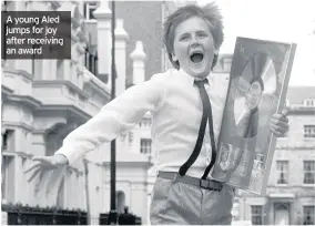  ??  ?? A young Aled jumps for joy after receiving an award