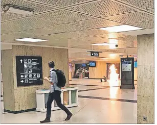  ?? REMY BONNAFFE VIA AP ?? In this Tuesday photo a man blows up an explosive device in a station in Brussels. The man was shot by soldiers afterwards in what prosecutor­s are treating as a “terrorist attack. He lay still for several hours while a bomb squad checked whether he was...