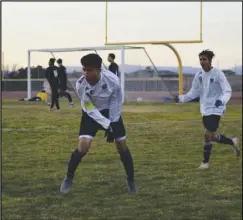  ?? MEGAN WIDICK/Special to the Valley Press ?? GOOOOAAALL­L! — Palmdale’s Brian Trujillo, left, celebrates after scoring a goal against Knight on Friday, while teammate Edgar Rios, right, who earned the assist, yells along with him. The Falcons won 1-0.