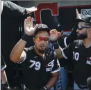  ?? JOSE M. OSORIO/TRIBUNE NEWS SERVICE ?? White Sox first baseman Jose Abreu highfives teammates before a game against the Reds in 2019.