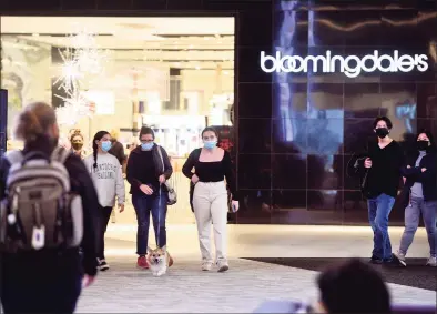  ?? Ned Gerard / Hearst Connecticu­t Media ?? Black Friday shoppers outside Bloomingda­le’s at The SoNo Collection in Norwalk. On the eve of December, Bloomingda­le’s and parent Macy’s were still filling jobs for the 2021 holiday season, offering pay for seasonal workers as high as $19.50 an hour depending on experience.