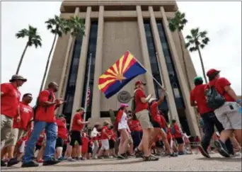  ?? MATT YORK — THE ASSOCIATED PRESS ?? Teachers rally outside of Arizona Gov. Doug Ducey’s Executive Tower Monday in Phoenix on their third day of walk outs. Teachers in Arizona and Colorado walked out of their classes over low salaries keeping hundreds of thousands of students out of...