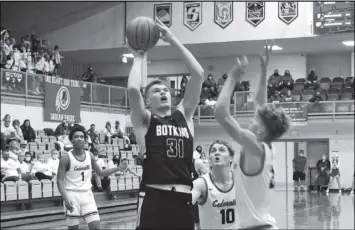  ?? Photos by Tony Arnold ?? Above, Jacob Pleiman of Botkins takes a shot as Trent Koning of Cedarville defends during Friday’s regional final. Below, head coach Sean Powell celebrates after finishing cutting down the net.