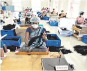  ??  ?? Factory workers process hair in Alinjivakk­am, Tamil Nadu