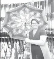  ??  ?? Suzanne Claveau shows off one of her popular inverse umbrellas.