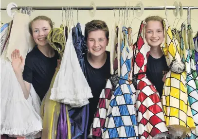  ?? PHOTO: GERARD O’BRIEN ?? Curtain call . . . Dunedin dancers Lucy Woodhouse (14), Harry Easton and Victoria Avery (both 13) amid the costumes they and other local students will don for their roles in the Royal New Zealand Ballet’s production of The Nutcracker.