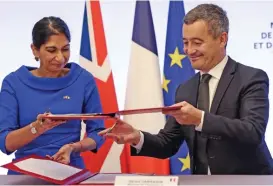  ?? (AFP) ?? French Interior Minister Gerald Darmanin (right) and Britain’s Home Secretary Suella Braverman sign a joint declaratio­n signature at the Hotel Beauvau Interior Ministry in Paris, on Monday