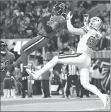  ??  ?? Atlanta Falcons middle linebacker Deion Jones (45) intercepts a ball in the end zone ahead of New Orleans Saints tight end Josh Hill (89) during the second half of an NFL football game, Thursday in Atlanta.