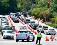  ?? Getty Images ?? Dodger Stadium should be hosting games. Instead, the traffic is for COVID-19 testing at the stadium.