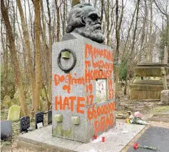  ??  ?? Philosophe­r Karl Marx’s grave site is seen vandalised with red paint in London. — Reuters photo