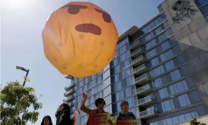  ??  ?? Protesters hold an inflatable angry emoji outside of Facebook’s annual shareholde­r meeting in Palo Alto, California. Photograph: Stephen Lam/Reuters